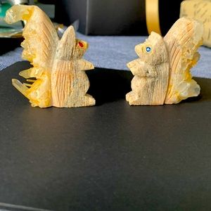 Beautiful carved squirrels, one with blue eyes remains